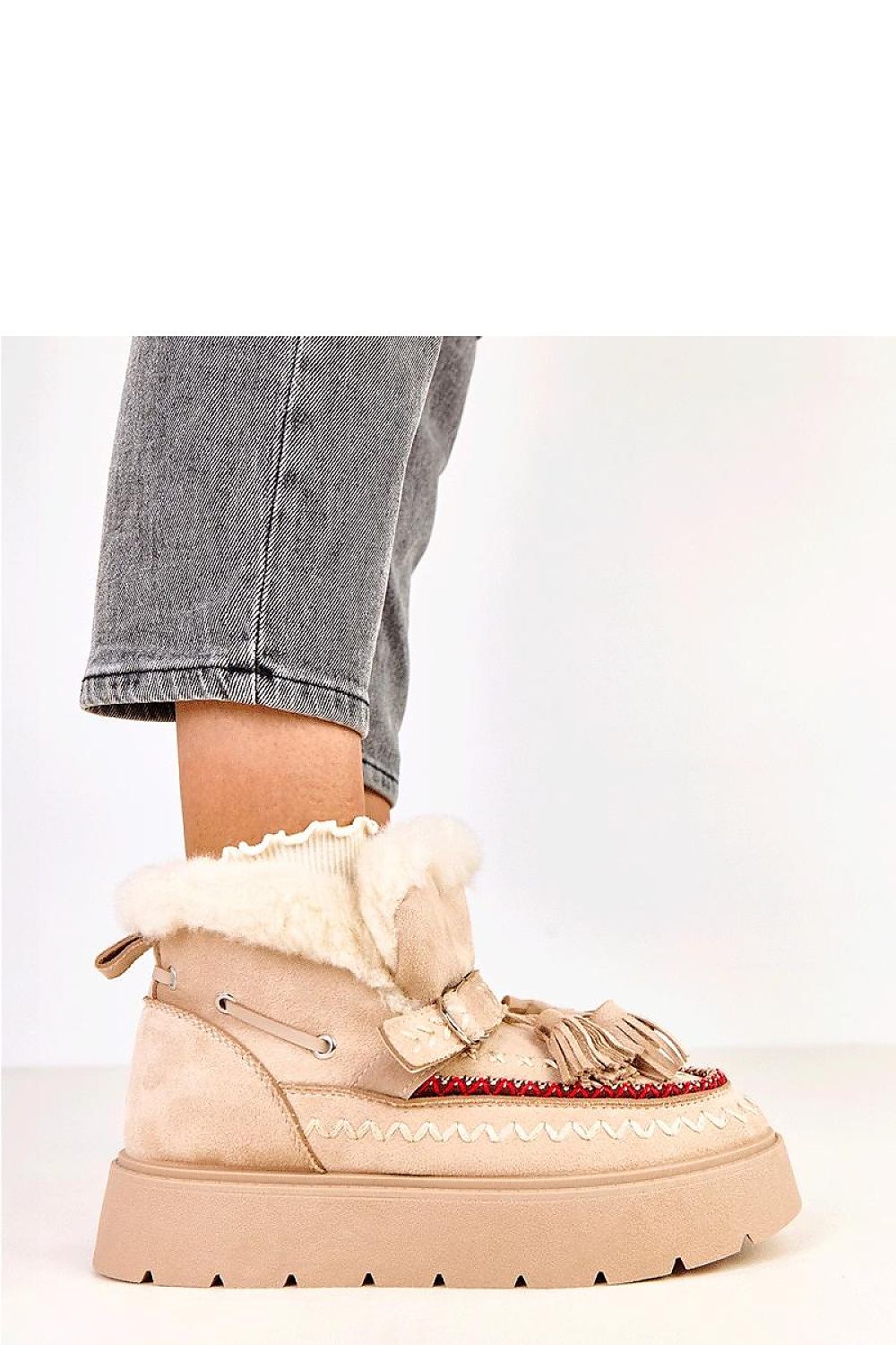 Solea winter slip-on boots showcasing chic decorative fringes and crafted from sustainable suede leather, ideal for fashionable winter wear.