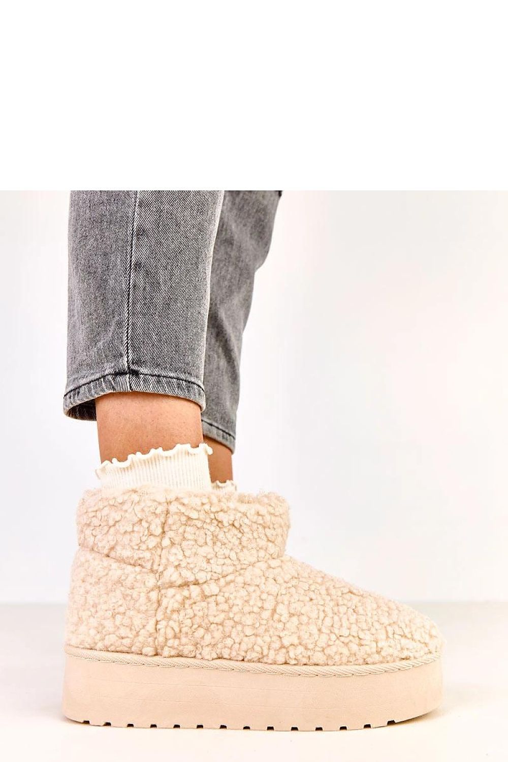 Close-up of Solea luxury slip-on snow boots featuring soft synthetic fur, highlighting the plush interior for warmth and comfort during cold weather.