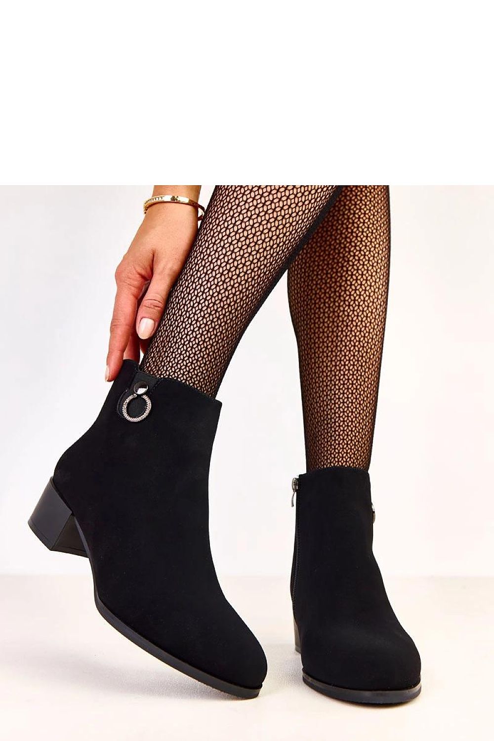 Close-up of Solea elegant heel boots in ecological suede, highlighting the exquisite decoration and soft texture.