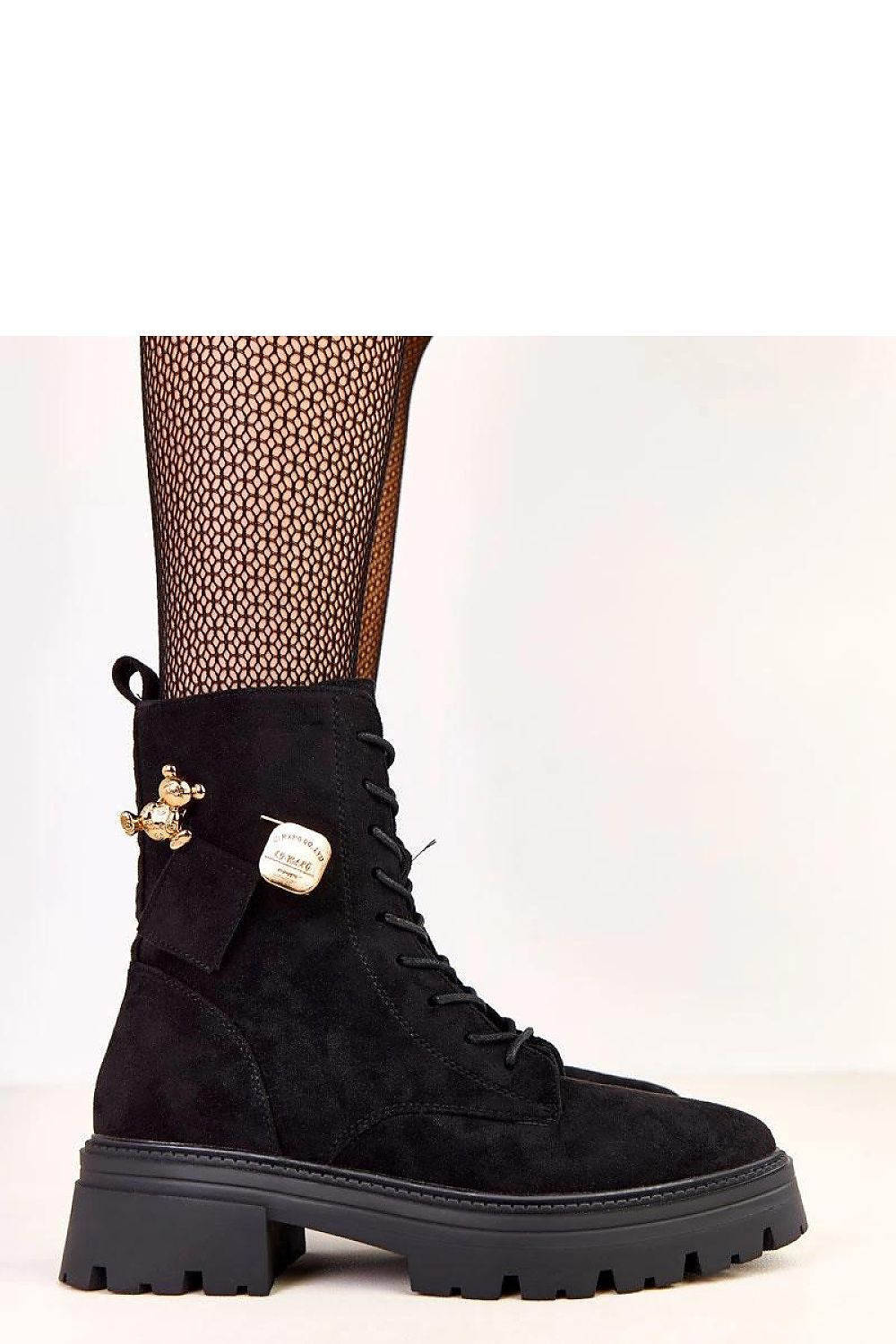 Close-up of Solea's luxurious women's work boots, showcasing the round toe design and decorative gold teddy bear charm on eco leather.