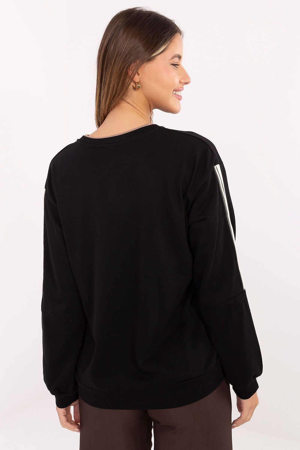 Close-up detail of Relevance oversized women's sweatshirt showcasing embroidered inscriptions for a contemporary, chic look.