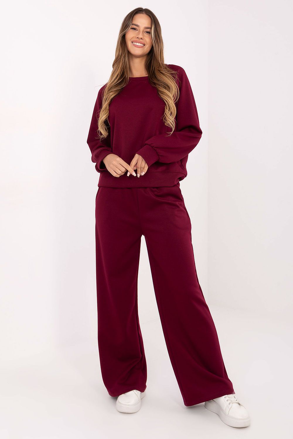 Luxurious women's tracksuit set featuring soft butter-like fabric by Factory Price, showcasing high-waisted pants and a loose blouse.