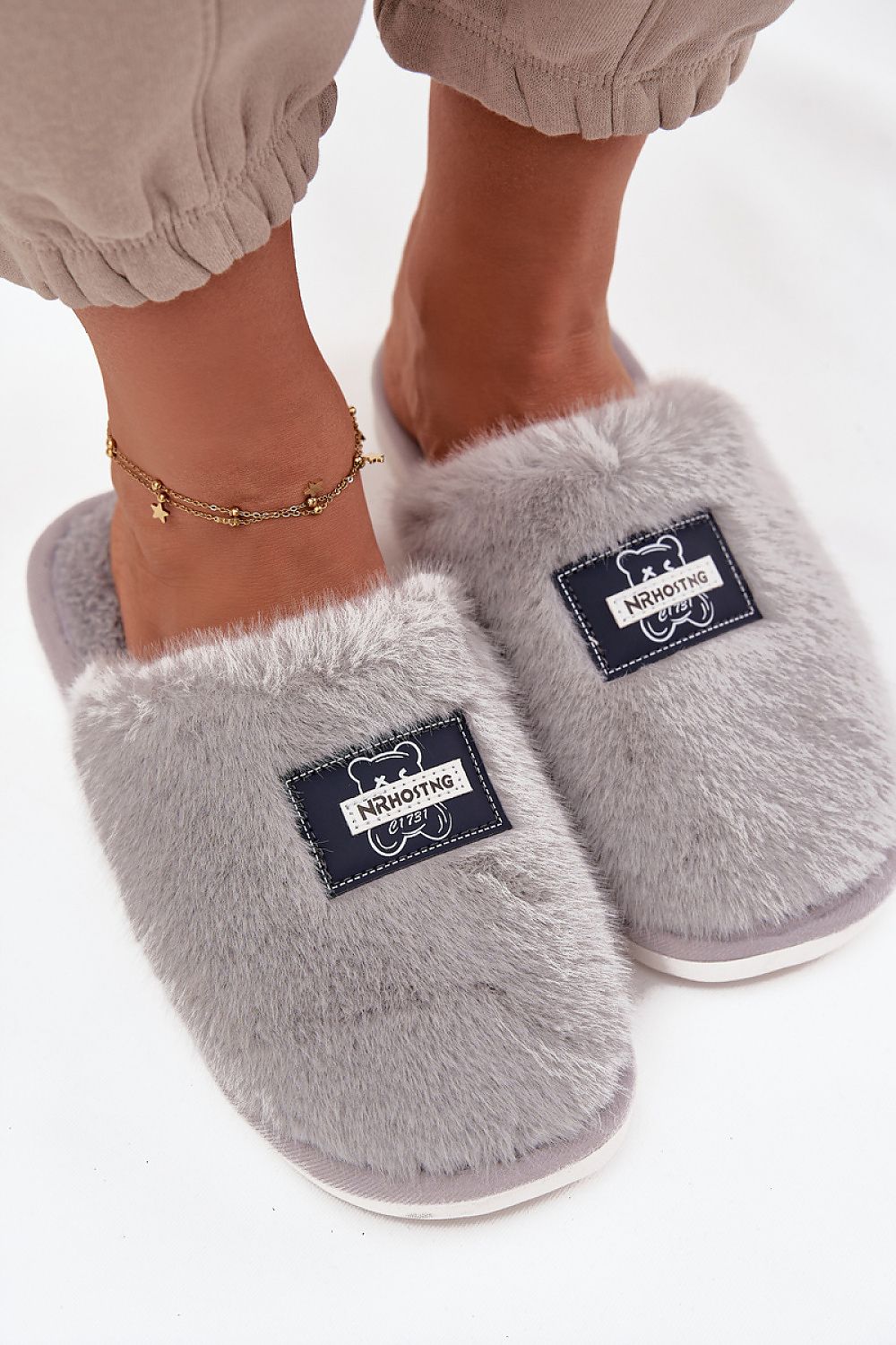 Elegant fur finish slippers for women from Step in style, adorned with a teddy bear patch, offering chic comfort for chilly days.