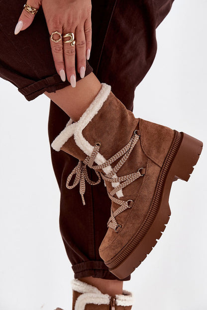 Sophisticated women's snow boots made from eco-suede, showcasing detailed lacing and faux fur trim, ideal for cold weather, brought to you by Step in Style.