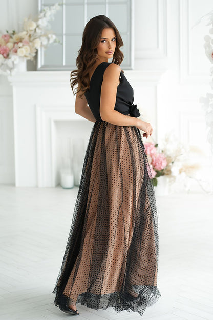 The luxurious double-layered bottom of the Bicotone long dress, showcasing a charming slit detail for a sophisticated look.