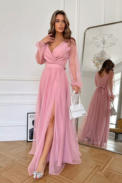 Elegant long dress by Bicotone, featuring a sultry slit and a chic belt, crafted from luxurious flowing fabric, perfect for special occasions.