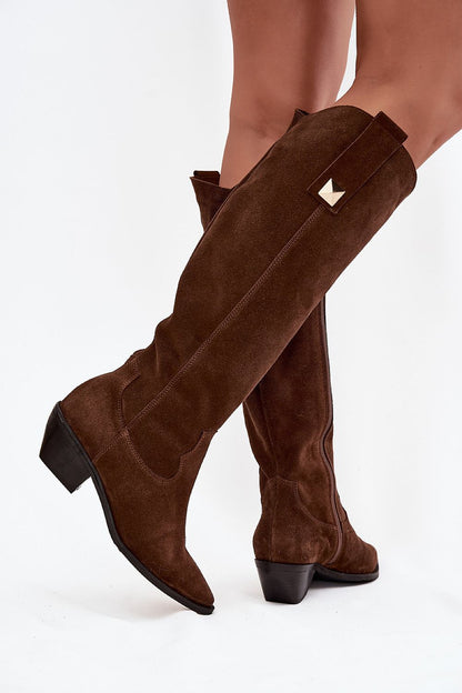 Close-up of luxurious suede cowgirl boots with pointed toes and cut-out heel, designed for elegance and comfort, by Step in Style.
