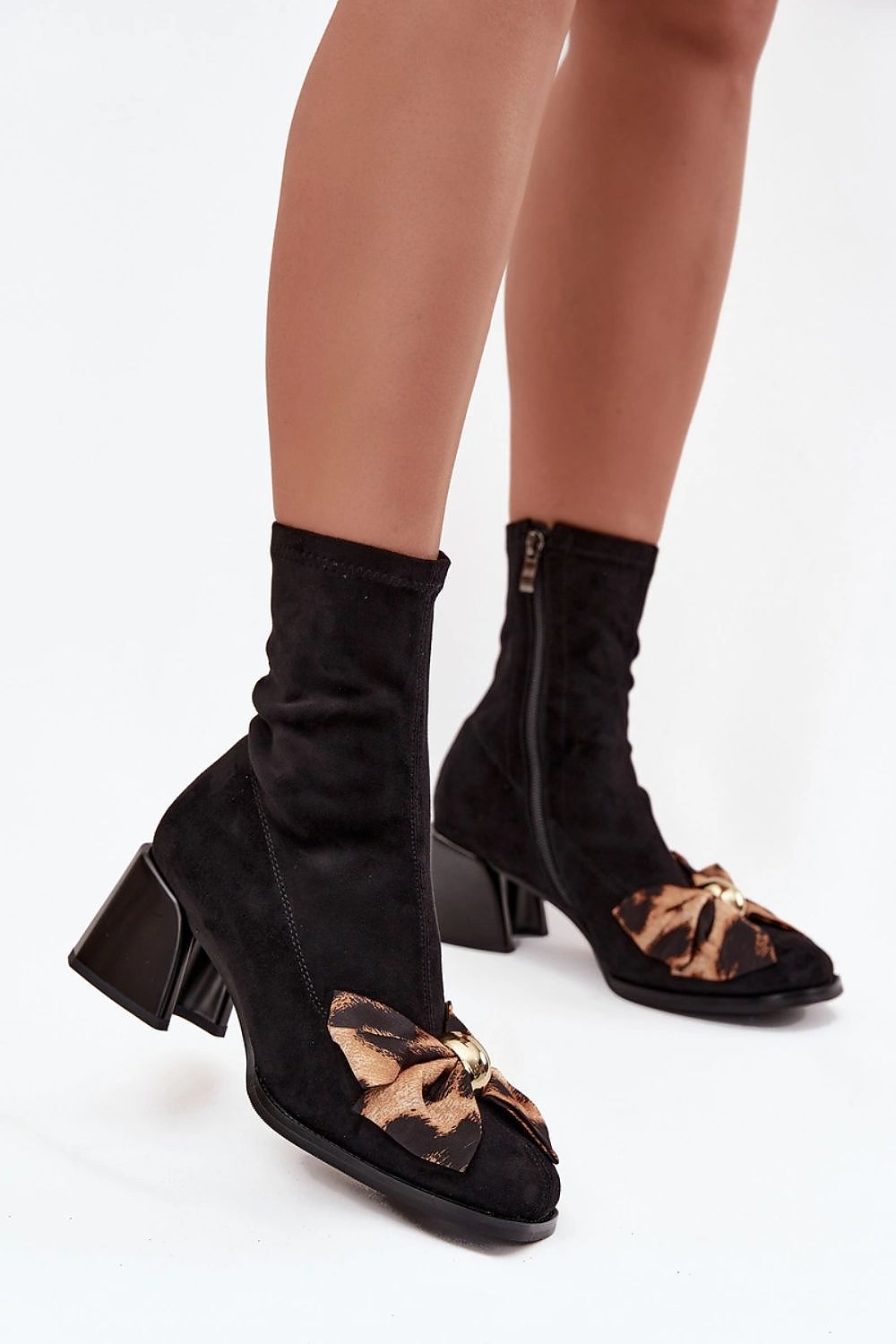 Close-up view of Step in Style eco suede ankle boots for women with a side zipper, block heel, and distinctive bow detail, showcasing luxury and comfort.