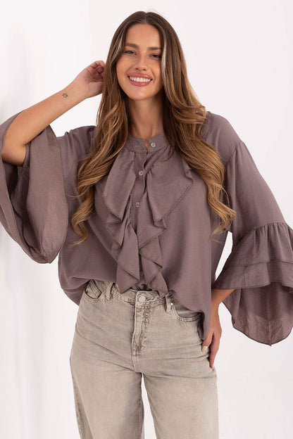 Elegant collarless women's shirt by Rue Paris featuring ruffle details, made of high-quality viscose. Perfect for everyday and special occasions.