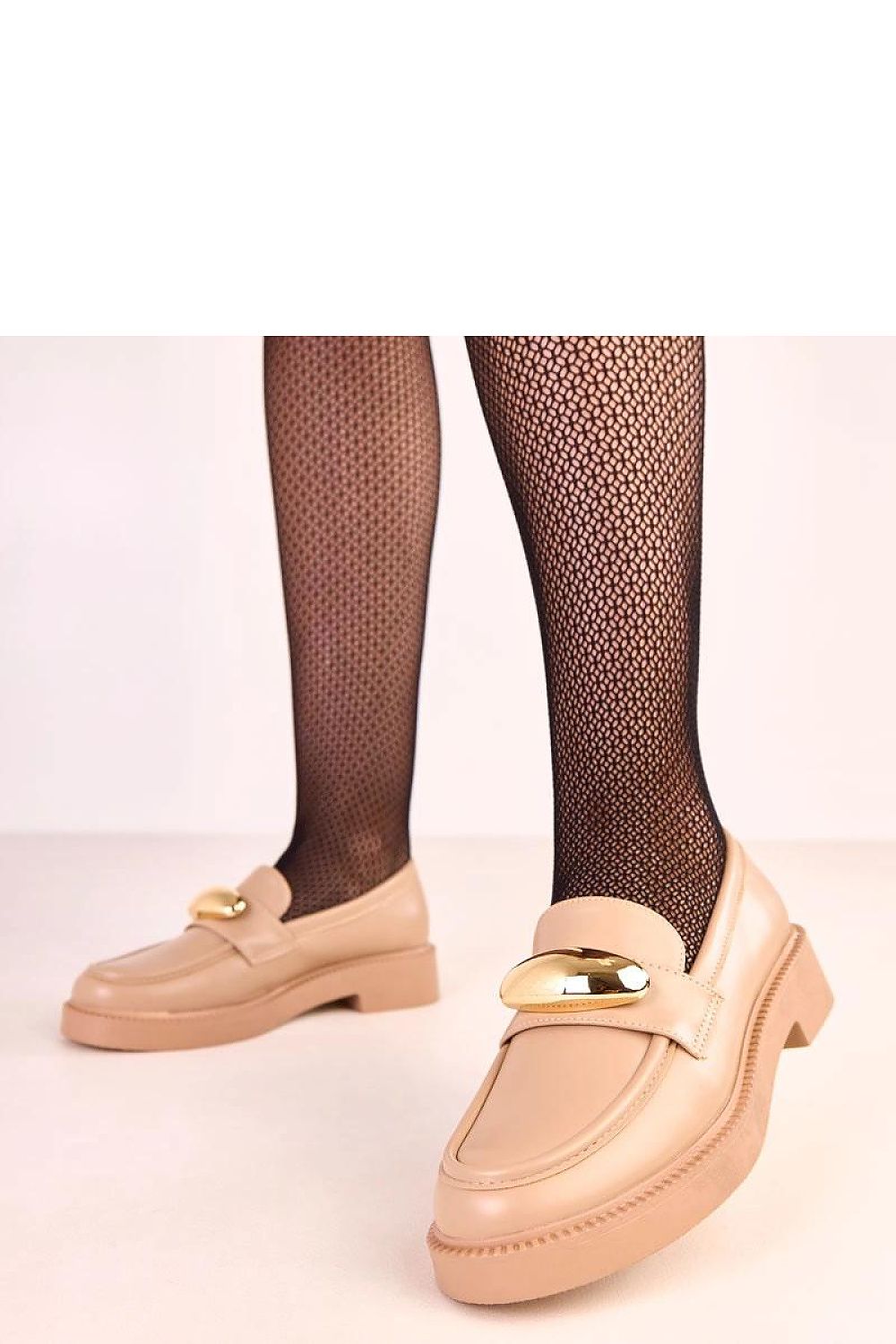 Luxurious Solea moccasins with soft synthetic leather construction, highlighted by a chic gold ornament, combining comfort with sophisticated style.