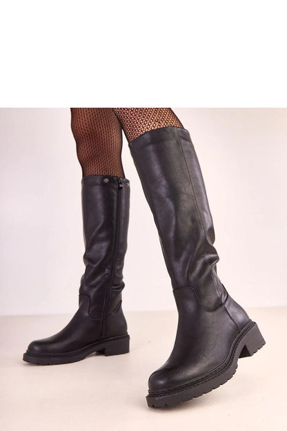 Solea's stylish thigh-high boots with detachable layer, showcasing a sleek design and warm interior, ideal for chic winter fashion.