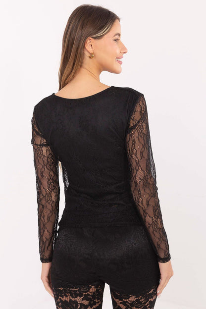 Model wearing Italy Moda's elegant lace blouse in a romantic setting, styled with elegant trousers, demonstrating its versatility for formal occasions.