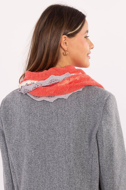 The elegant AT triangular neckerchief scarf draped elegantly, highlighting its feminine design and luxurious viscose material with lace and pearl details.