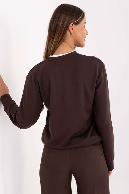 Relevance women's blouse in EU size 0, showcasing an elegant design with brooches, ideal for pairing with jeans or skirts.