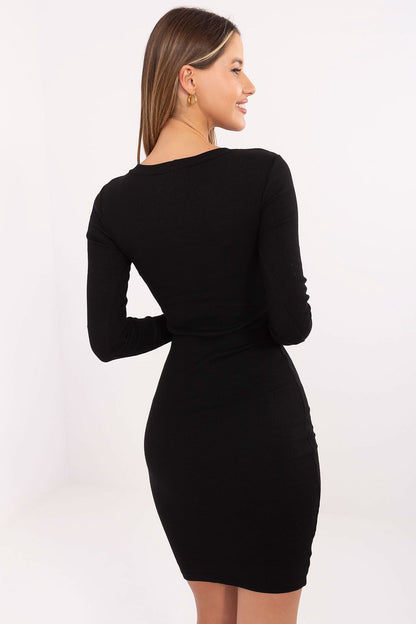 Model wearing the chic Ribbed Bodycon Daydress by Rue Paris, featuring a round neckline and long sleeves, demonstrating versatile styling options from elegant to casual.