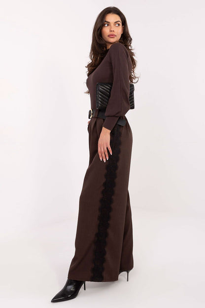 Model wearing Rue Paris Ribbed Turtleneck Blouse paired elegantly with trousers, demonstrating its classic design and comfort.