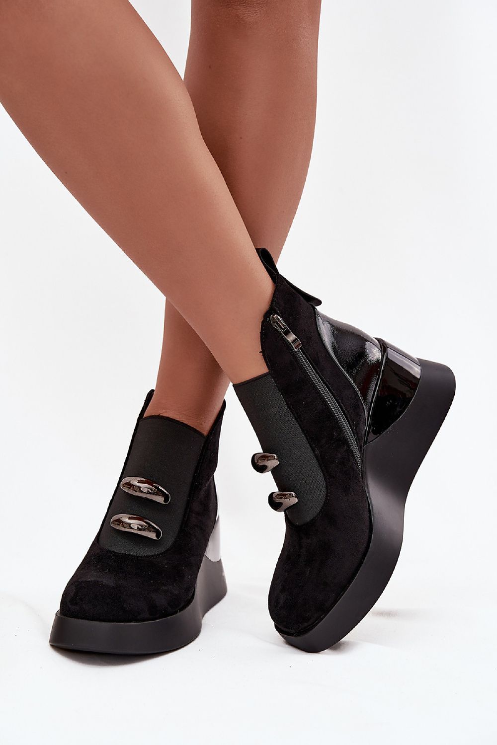 Close-up of luxury women's eco suede buskin boots with decorative elements from Step in Style, showcasing the elegant side zipper and wedge heel.