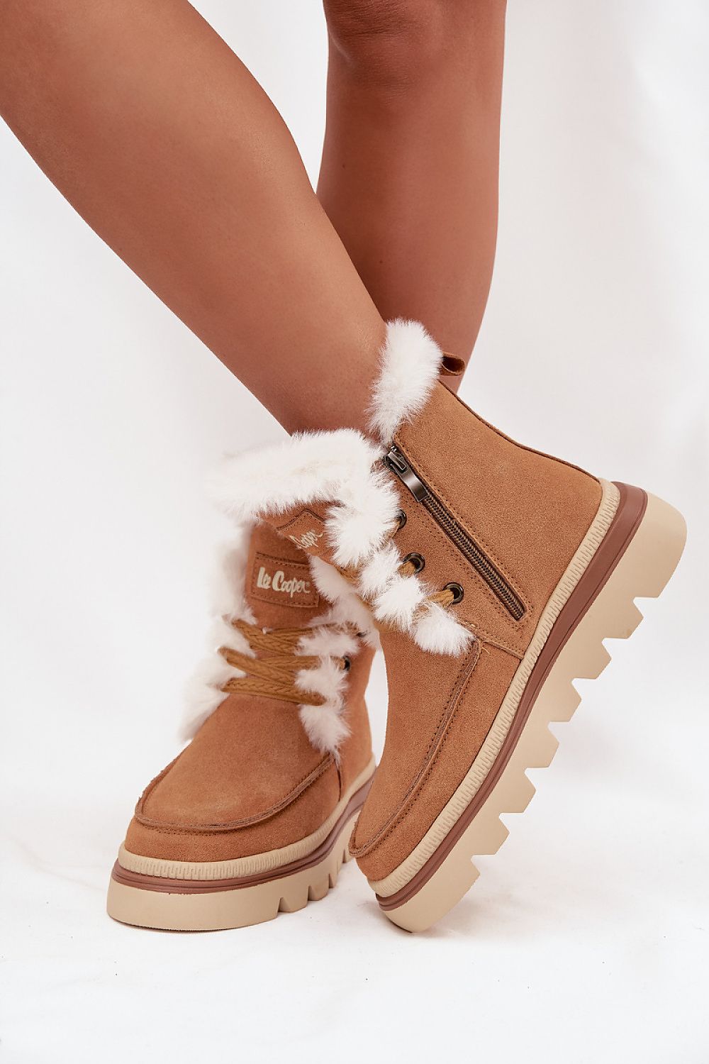 Elegant Lee Cooper women's suede snow boots featuring luxurious fur lining, durable rubber sole, and convenient zipper closure, perfect for winter style and comfort.