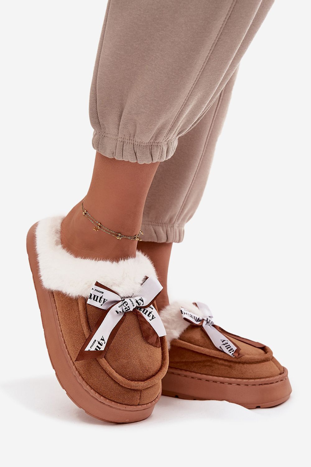 Stylish and warm women's eco-suede slippers with a fluffy fur lining and fashionable bow detail, presented by Step in Style.