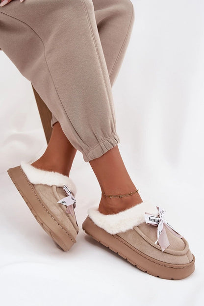 Chic luxury women's slippers crafted from eco-suede, with a plush fur interior and bow accent, designed by Step in Style for ultimate comfort.
