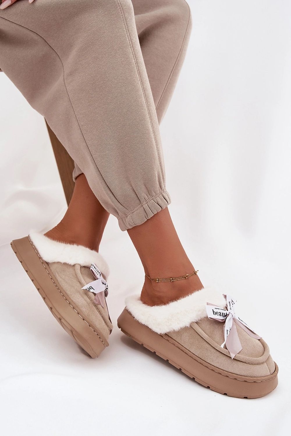 Step in Style's sumptuous luxurious women's eco-suede slippers designed with a fluffy fur interior, enhancing warmth and elegance.
