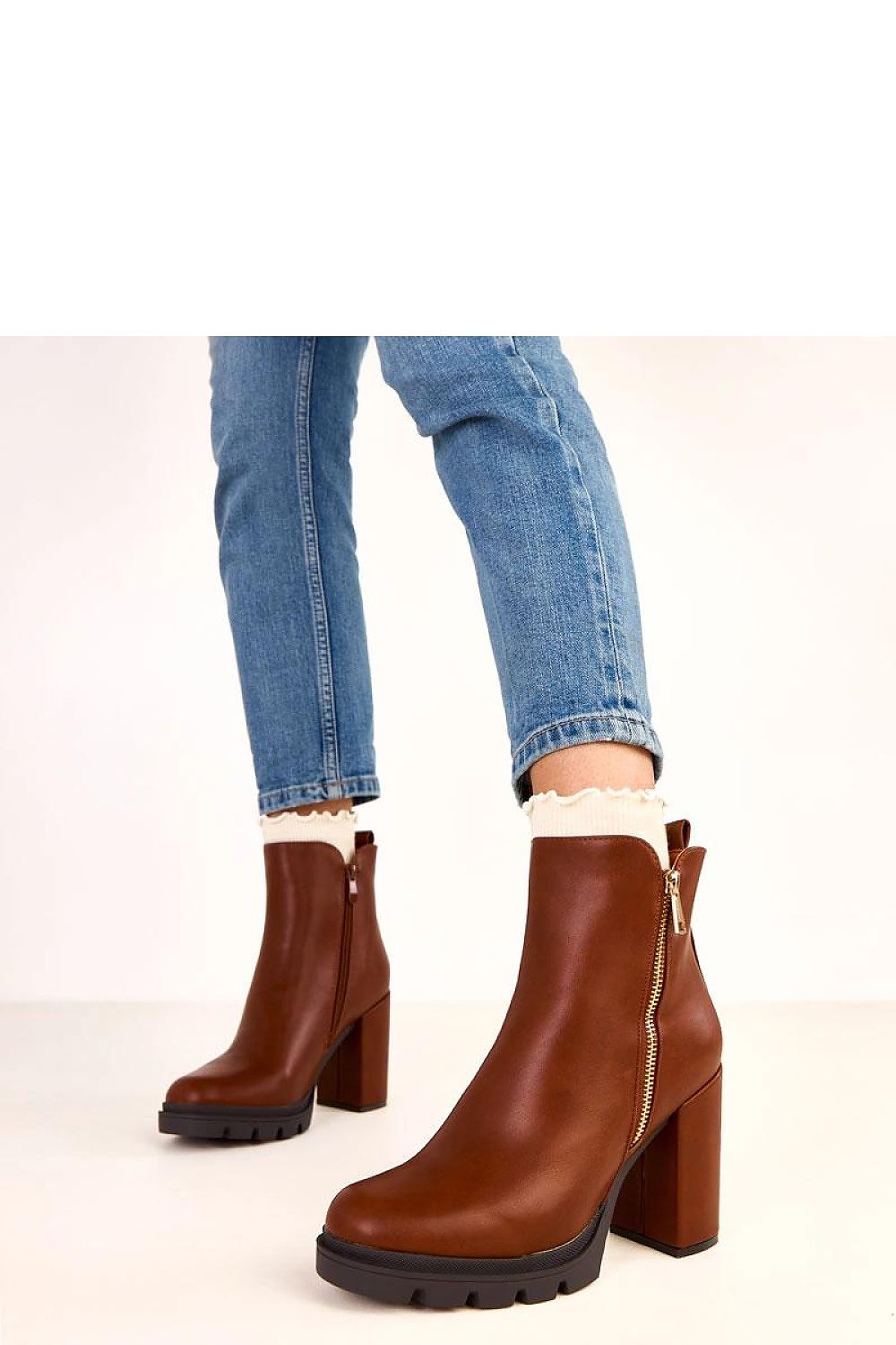 Chic Solea eco-leather ankle boots showcasing a stable 10 cm column heel and round toe design, ideal for sophisticated styling and comfort.