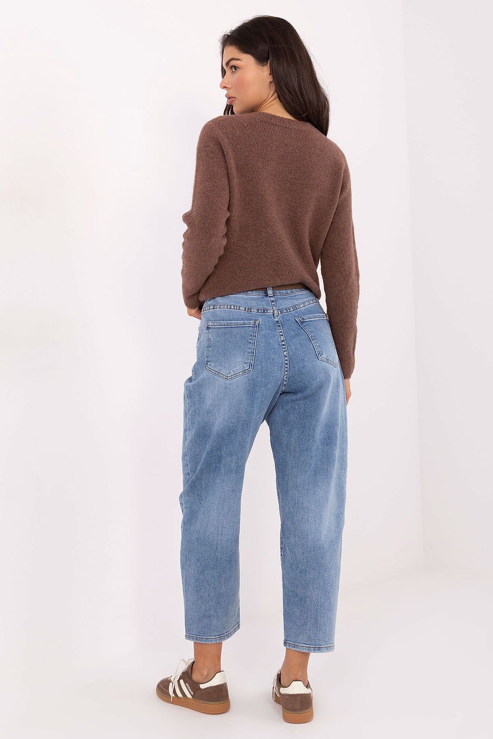 Chic look of women's high-waisted carrot jeans styled with a trendy top, ideal for casual outings by Factory Price.