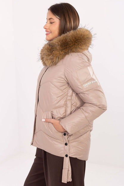 Model wearing MBM's stylish women's down jacket, highlighting the detachable fur hood and beautiful fit for a luxurious autumn/winter look.