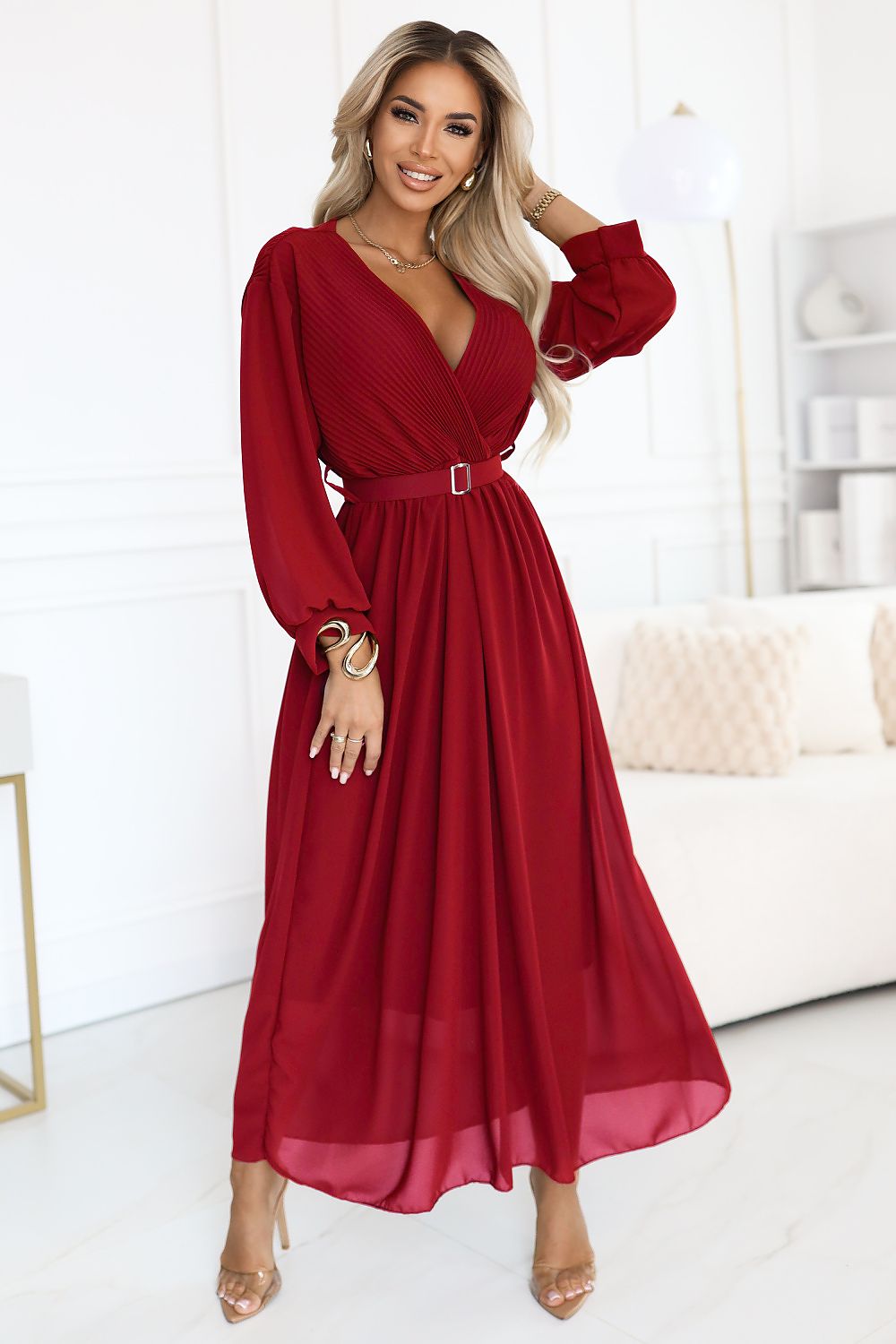 Elegant burgundy maxi dress with sweetheart neckline by Numoco, perfect for formal occasions such as weddings and romantic dinners, featuring a flared bottom and waist belt for a flattering silhouette.