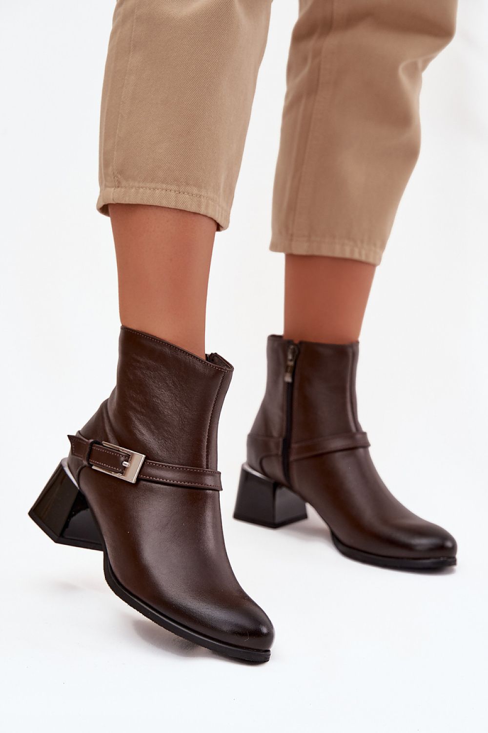 Elegant women's ankle boots by Step in Style crafted from natural leather, featuring a decorative strap and 5.5 cm block heel, ideal for refined cold-weather fashion.