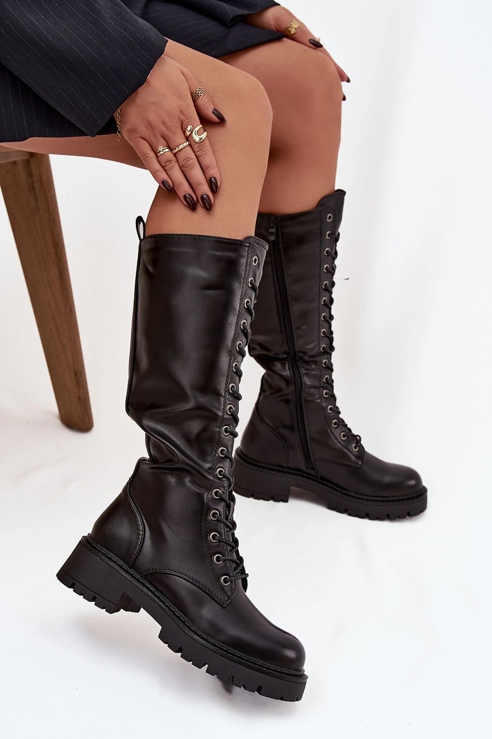 Stylish women's thigh-high combat boots by Step in Style, showcasing eco leather material, a zipper closure, and lacing detail for a perfect fit and modern appeal.