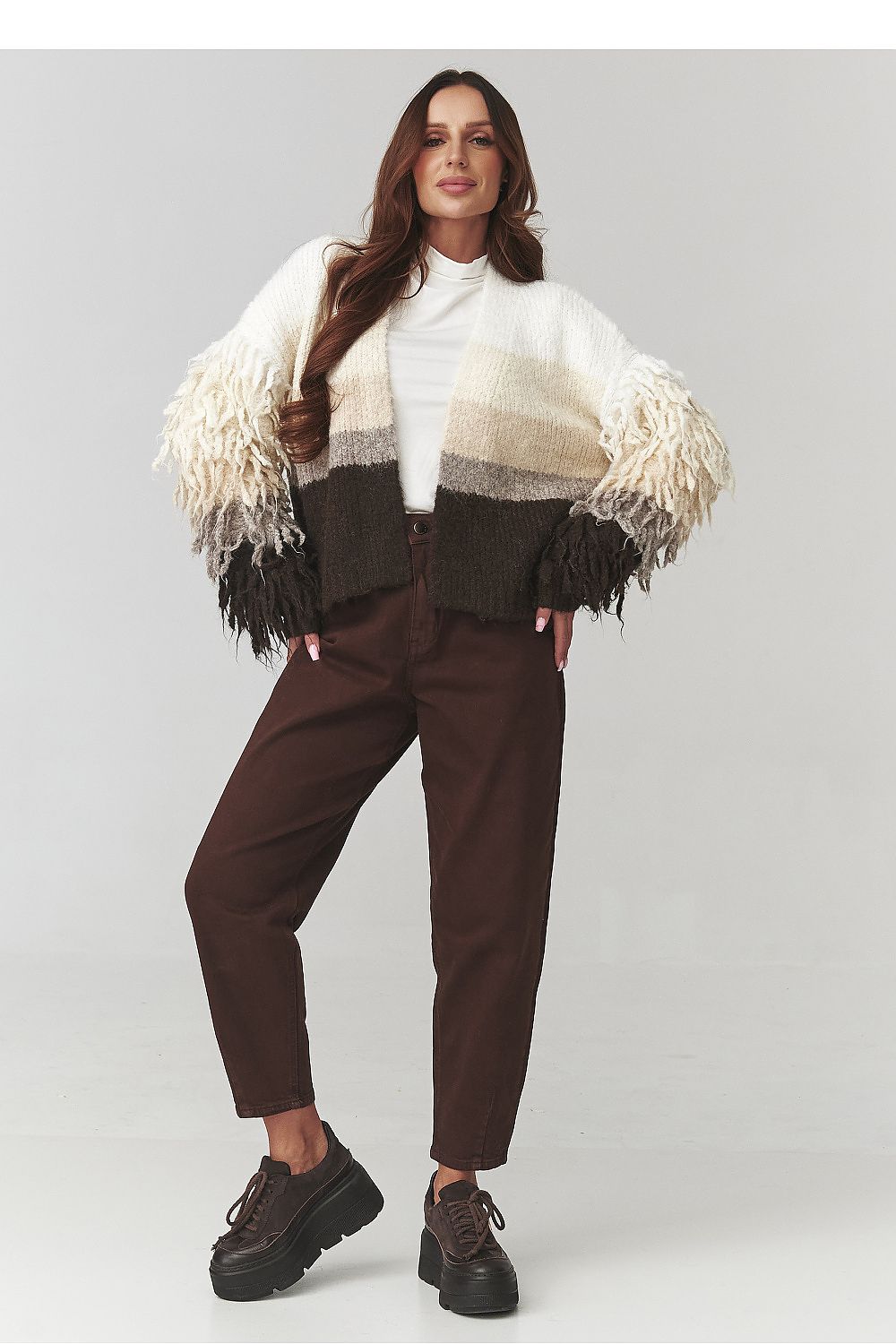 Close-up of Makadamia's stylish ombre cardigan in grey and beige, highlighting the soft fabric and unique fringe detail.