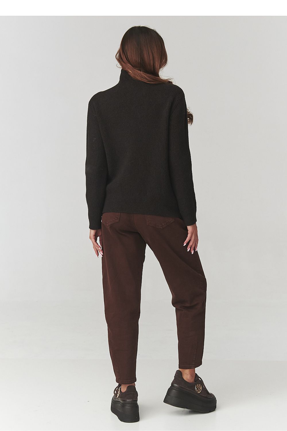 Stylish Makadamia Women's Turtleneck Sweater paired with high-waisted pants, embodying effortless smart casual elegance.