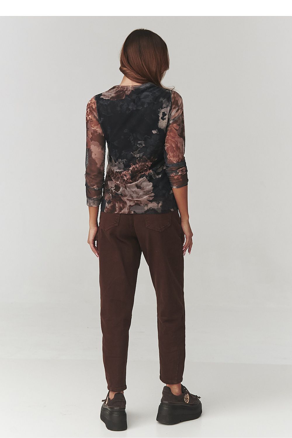 Close-up of Makadamia's floral print blouse featuring turtleneck detail, crafted from luxurious semi-transparent fabric ideal for sophisticated styling.
