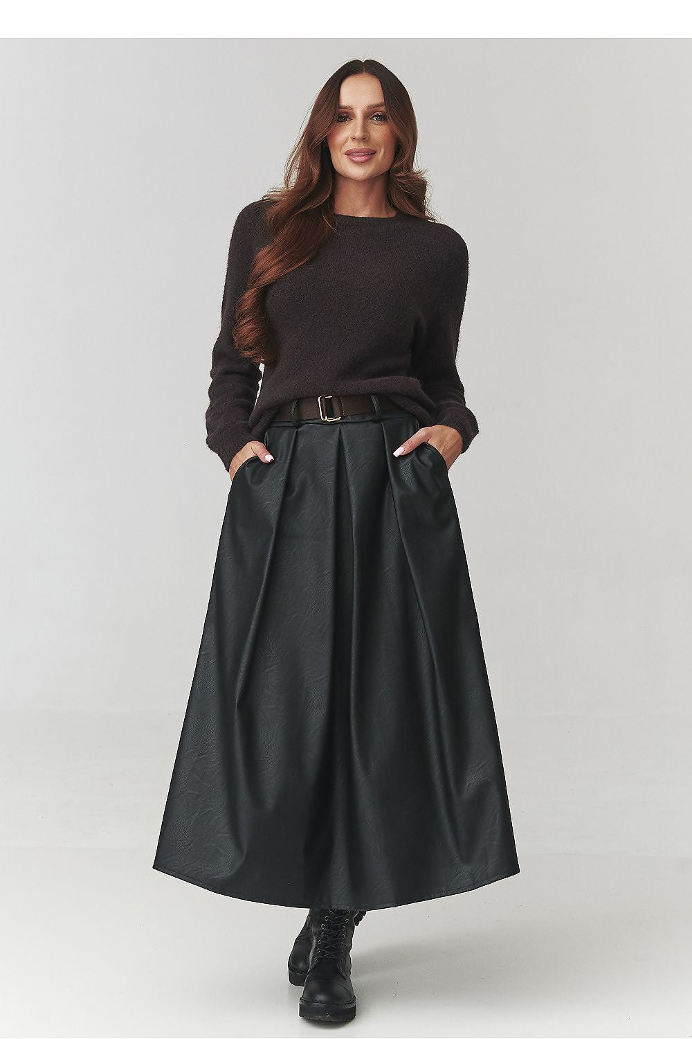 Chic view of the Makadamia black faux leather midi skirt, showcasing its elegant flared silhouette and luxurious material for sophisticated fashion.