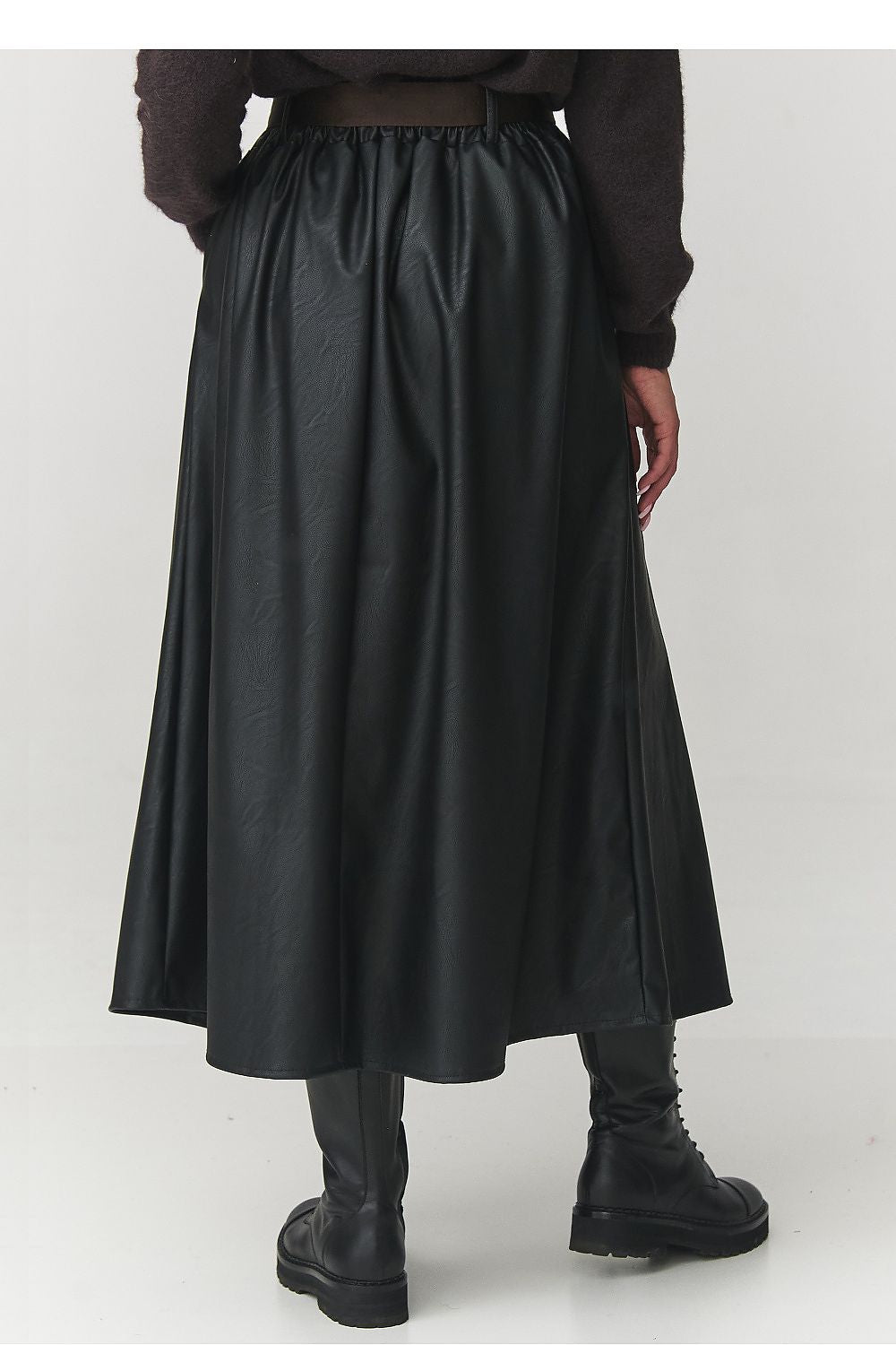 Stylishly detailed image of the Makadamia elegant black faux leather skirt, highlighting the soft texture and modern design elements ideal for various occasions.