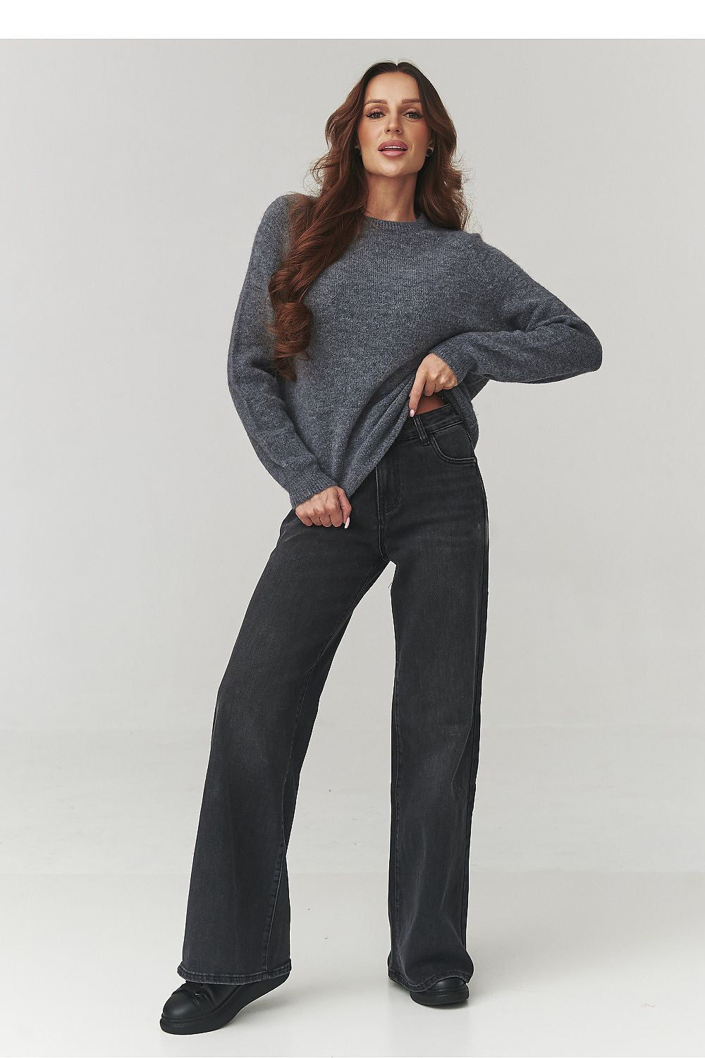 Luxurious Makadamia women's sweater showcasing a flattering loose fit and chic dropped shoulders, ideal for an elegant casual look.