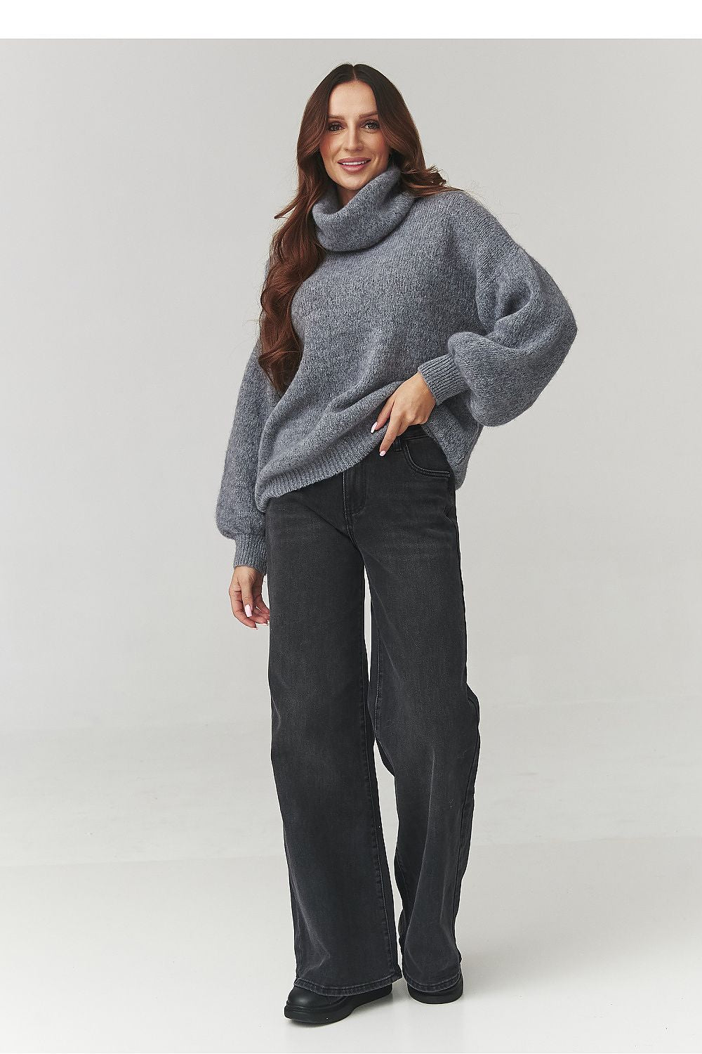 Stylish Makadamia oversized turtleneck in soft knit, showcasing a relaxed silhouette ideal for both casual and elegant outfits.