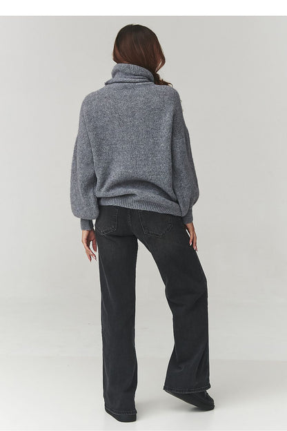 Luxurious Makadamia oversized turtleneck sweater for women, showcasing soft knitwear in a relaxed fit with elegant wide sleeves.