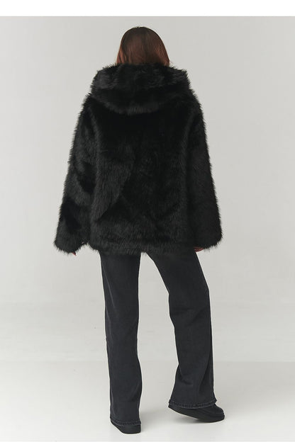 Front view of Makadamia's lightweight women's eco fur coat in classic black, designed for comfort and elegance.