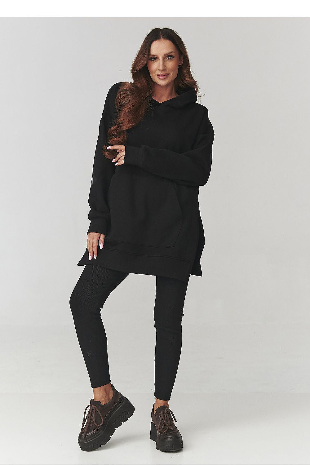 Soft and luxurious women's activewear set by Makadamia showcasing a longer hoodie and form-fitting leggings, ideal for versatile styling.