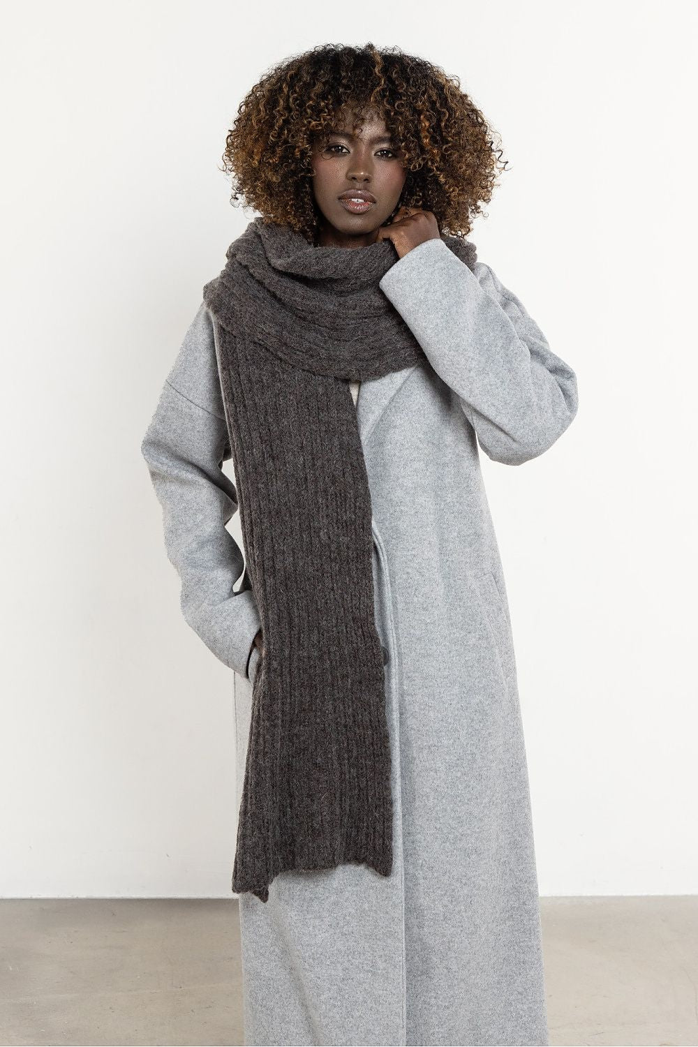 Luxurious long scarf made of kid mohair and wool from Awama, showcasing its soft texture and warm, ribbed design, perfect for winter elegance.