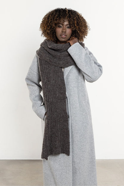 Luxurious long scarf made of kid mohair and wool from Awama, showcasing its soft texture and warm, ribbed design, perfect for winter elegance.