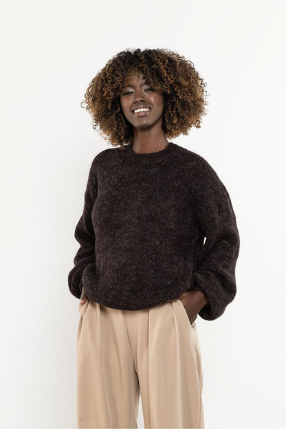 Elegant Awama women's sweater worn in a stylish setting, highlighting its versatility for various seasons and occasions.