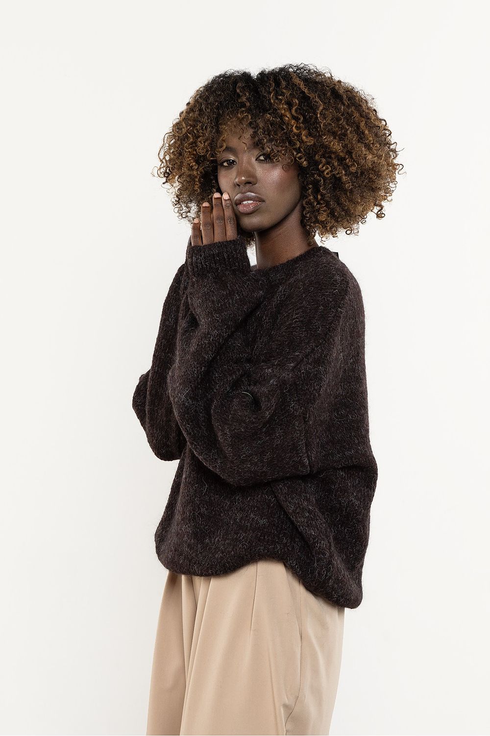 Flat lay of the luxurious Awama wool and kid mohair sweater in soft tones, emphasizing its versatile style for fashionable women.