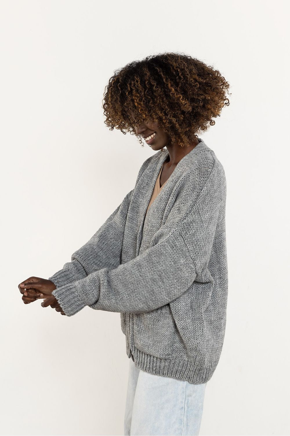 An exquisite wool blend cardigan by Awama, highlighting its button closure and stylish pockets, perfect for autumn-winter wear.