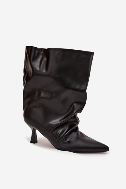 Close-up of luxurious eco-leather texture on women's ankle boots with a stylish slim heel from Step in Style.