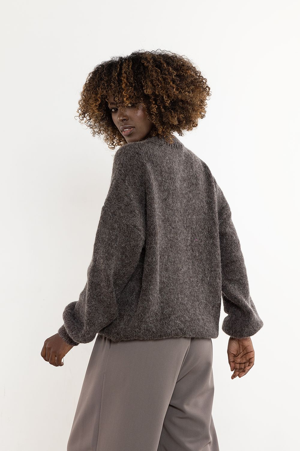 Stylish model wearing the luxurious Awama wool and kid mohair women's sweater, highlighting the elegant drape and comfort of this premium piece.