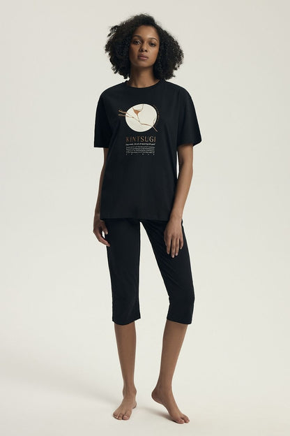 Luxury Women's Cotton Pyjamas Set by Henderson featuring a modern fitted cut with stylish print, short-sleeve top and 3/4 slim fit pants, designed for comfort and elegance.