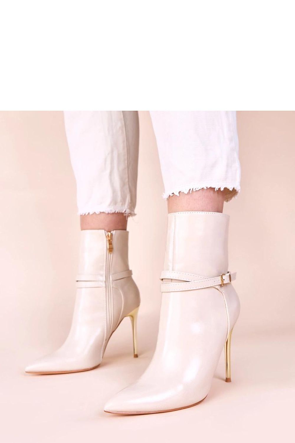 Elegant beige ankle boots with shiny gold stiletto heels by Solea, showcasing luxurious craftsmanship and sophisticated style, perfect addition to women's footwear collection.